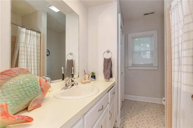 bathroom with tile patterned floors and vanity