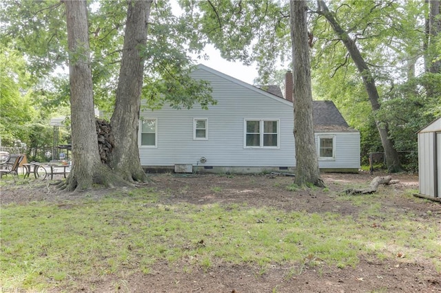 rear view of property with a lawn