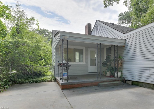 doorway to property featuring a patio area and covered porch