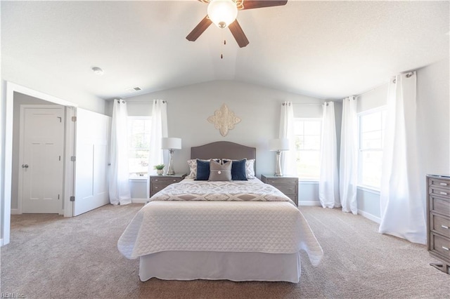 bedroom with light colored carpet, ceiling fan, and lofted ceiling