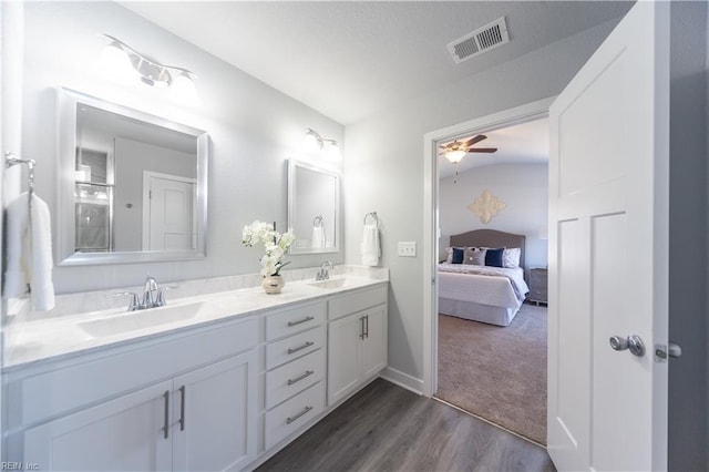 bathroom featuring ceiling fan, hardwood / wood-style floors, vanity, and vaulted ceiling