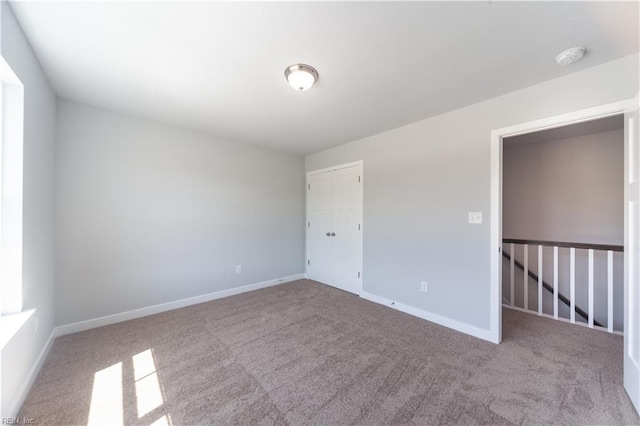 unfurnished room with light colored carpet