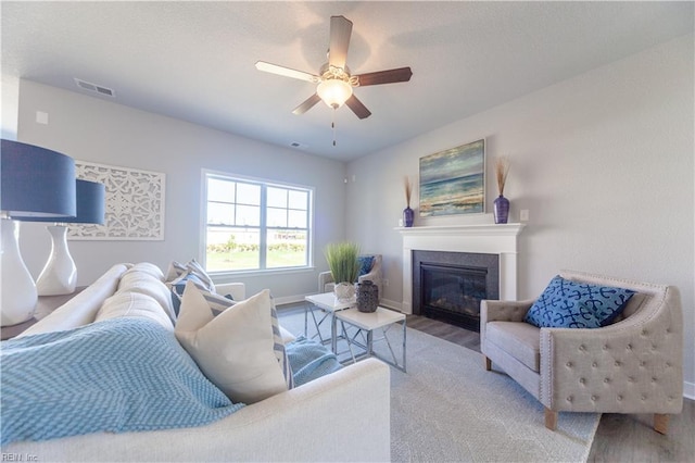 living room featuring hardwood / wood-style floors and ceiling fan