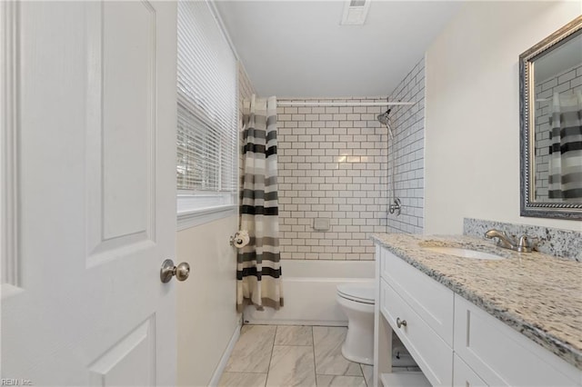 full bathroom with shower / bath combination with curtain, vanity, and toilet