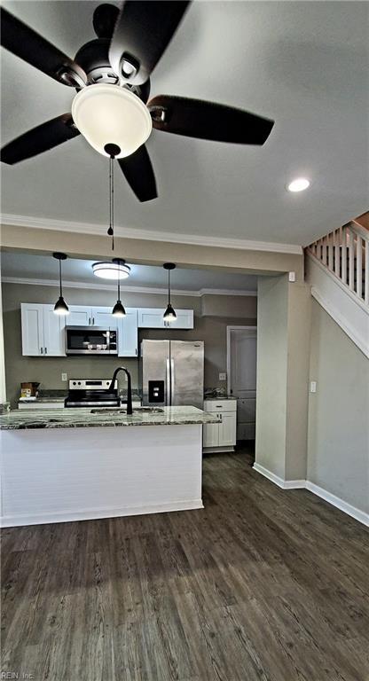 kitchen featuring white cabinets, pendant lighting, dark stone countertops, and appliances with stainless steel finishes