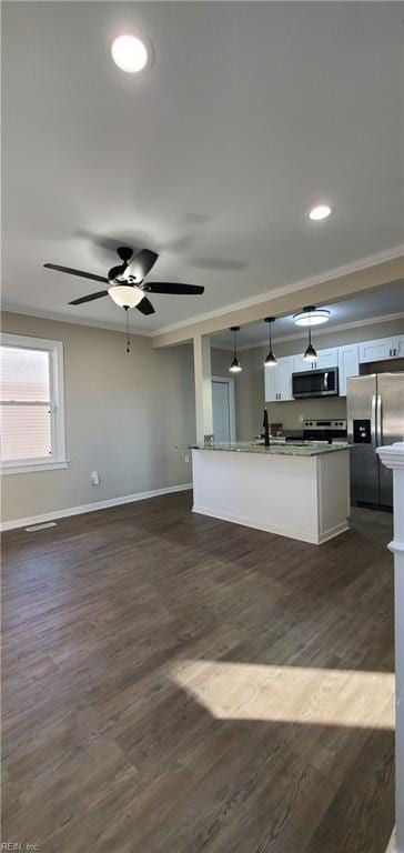 kitchen featuring white cabinetry, crown molding, hanging light fixtures, and appliances with stainless steel finishes