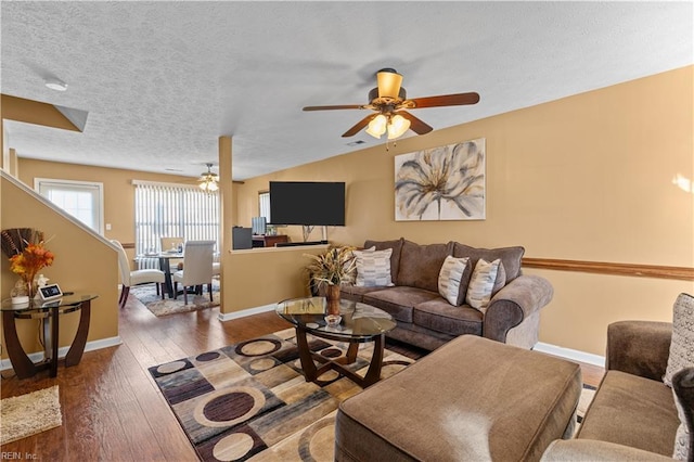 living room with ceiling fan, wood-type flooring, and a textured ceiling