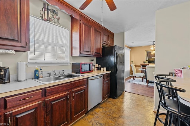 kitchen with dishwasher, black refrigerator, sink, and ceiling fan