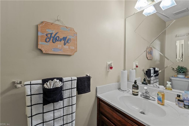 bathroom featuring vanity and toilet