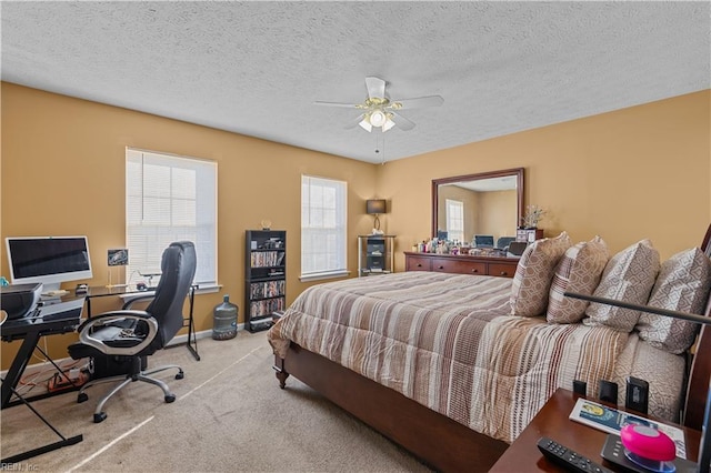 carpeted bedroom with ceiling fan and a textured ceiling