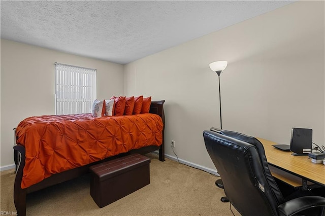 bedroom with light colored carpet and a textured ceiling