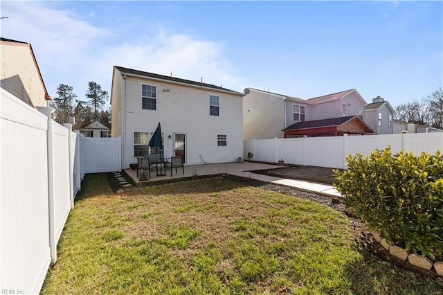 back of property featuring a yard and a patio