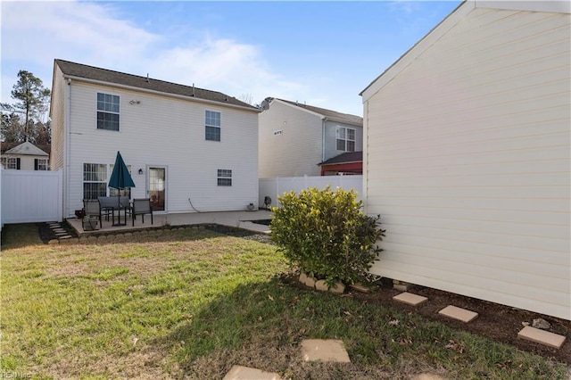 rear view of property with a lawn and a patio