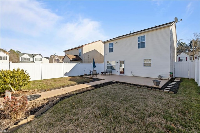 back of property with a patio area and a lawn