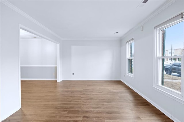 empty room with wood-type flooring and ornamental molding