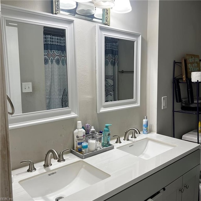 bathroom featuring vanity and curtained shower