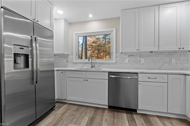 kitchen with sink, white cabinets, and stainless steel appliances