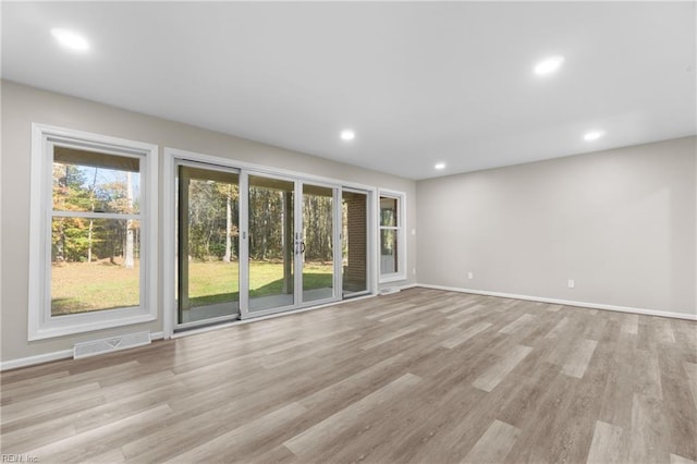 unfurnished living room featuring light wood-type flooring