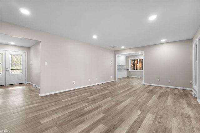 unfurnished living room featuring light wood-type flooring