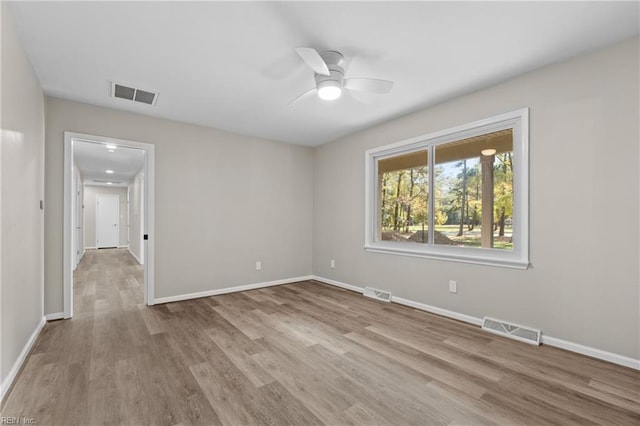 empty room featuring ceiling fan and light hardwood / wood-style floors