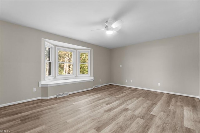 unfurnished room with light wood-type flooring and ceiling fan