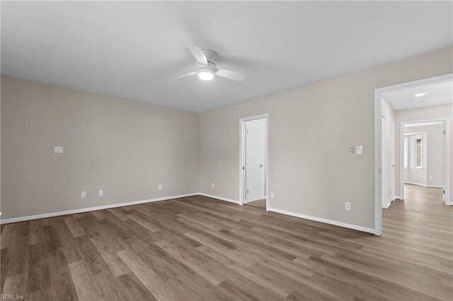 unfurnished room with ceiling fan and hardwood / wood-style floors