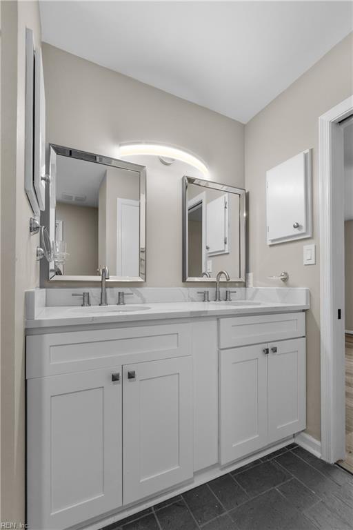 bathroom featuring tile patterned flooring and vanity