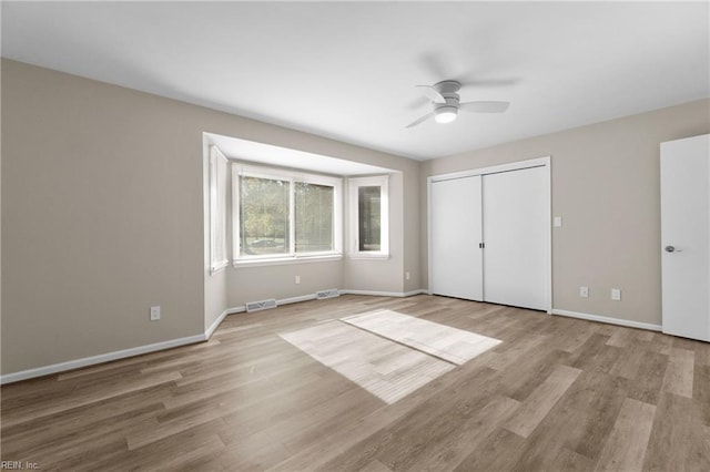 unfurnished bedroom with a closet, ceiling fan, and light hardwood / wood-style flooring