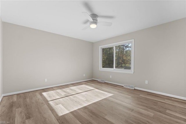 empty room featuring ceiling fan and light hardwood / wood-style floors