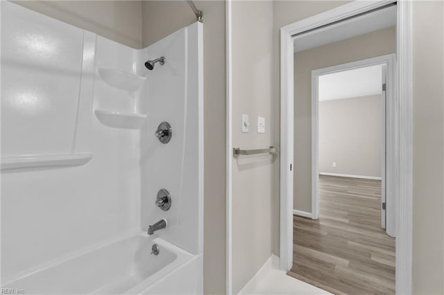 bathroom featuring wood-type flooring and bathing tub / shower combination