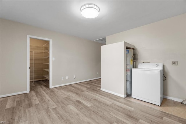 washroom with washer / dryer, light wood-type flooring, and water heater