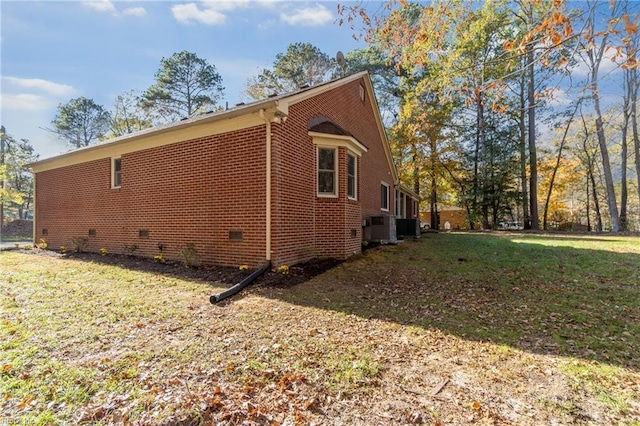 view of home's exterior with a lawn and cooling unit