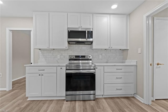 kitchen featuring white cabinets, light hardwood / wood-style floors, and appliances with stainless steel finishes