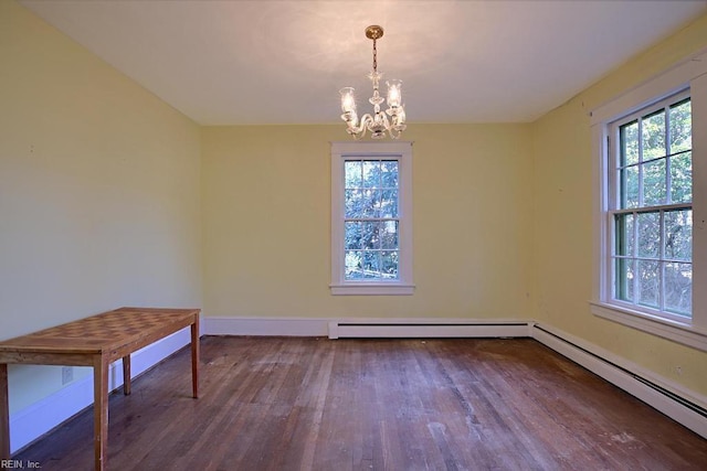 unfurnished dining area with hardwood / wood-style floors, a baseboard heating unit, and an inviting chandelier