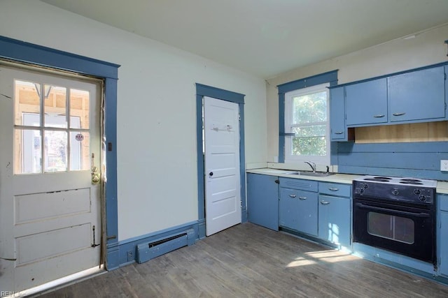 kitchen featuring hardwood / wood-style floors, a baseboard radiator, black electric range oven, and sink