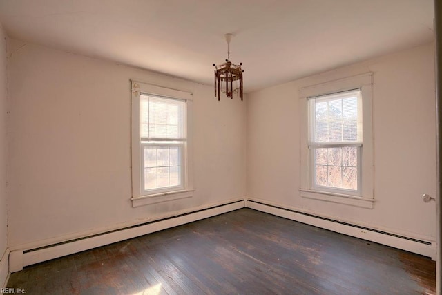 unfurnished room with dark hardwood / wood-style flooring and a baseboard radiator