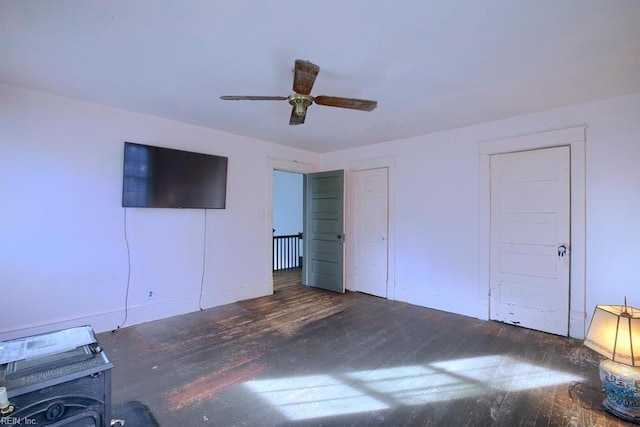 unfurnished bedroom featuring ceiling fan and dark hardwood / wood-style flooring