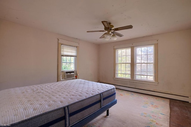 bedroom featuring ceiling fan, cooling unit, and a baseboard heating unit