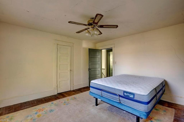 bedroom featuring ceiling fan and dark hardwood / wood-style flooring