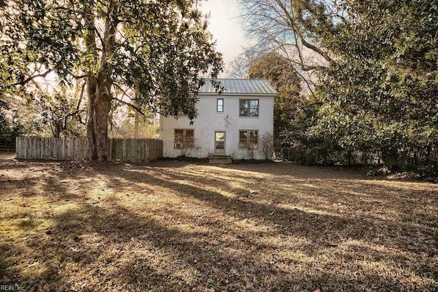 rear view of property with a lawn