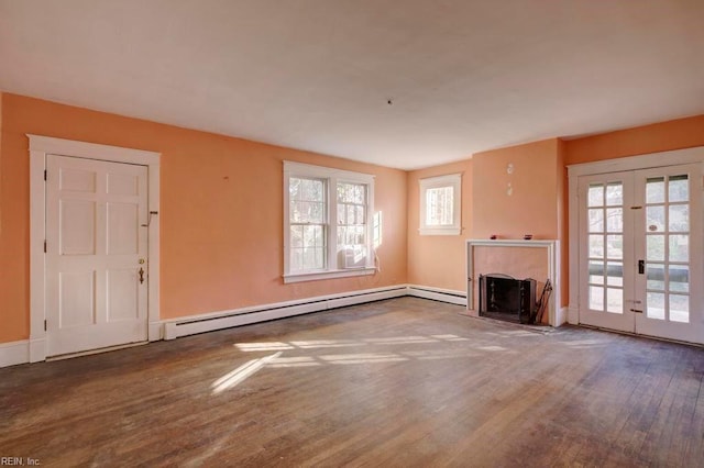 unfurnished living room featuring french doors, a baseboard radiator, and wood-type flooring