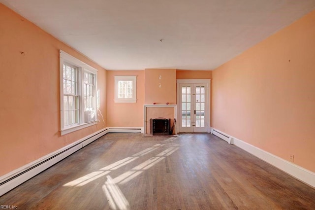 unfurnished living room with french doors, a baseboard radiator, and wood-type flooring