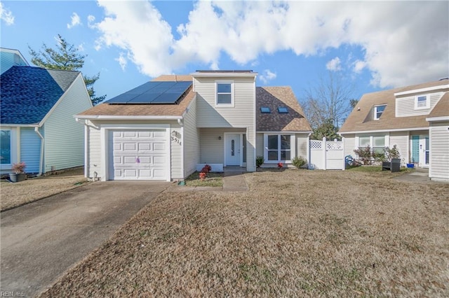 view of front of property with solar panels and a garage