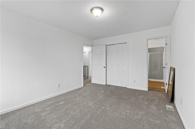 unfurnished bedroom featuring dark colored carpet