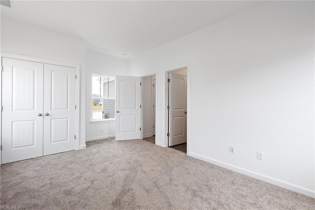 unfurnished bedroom featuring carpet floors and a closet