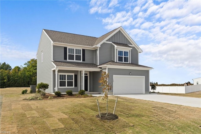 view of front of home with a front yard, a garage, and central AC unit