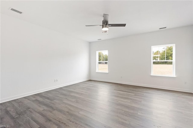 unfurnished room with ceiling fan and hardwood / wood-style flooring