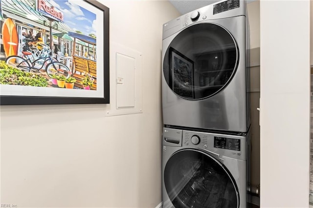 washroom with stacked washing maching and dryer