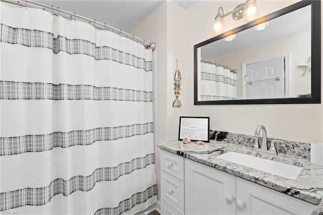 bathroom with a shower with shower curtain and vanity