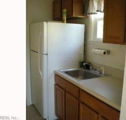 kitchen with white refrigerator and sink